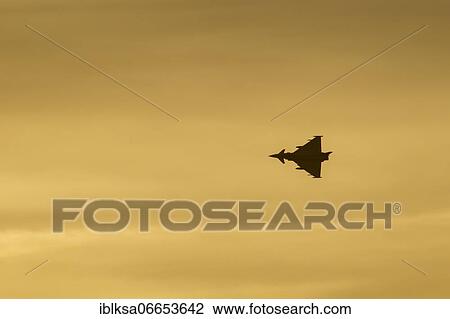 Stock Image - Eurofighter Typhoon aircraft in flight of the Royal air force at sunset, Lincolnshire, England, United Kingdom, Europe. Fotosearch