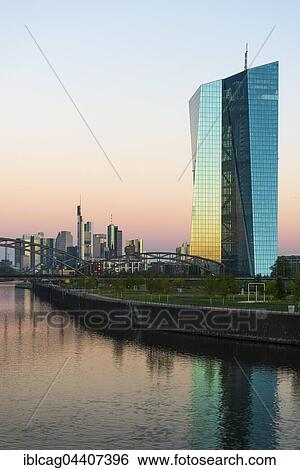 Stock Photograph - European Central Bank at sunrise, in front of Frankfurt skyline, Frankfurt, Hesse, Germany, Europe. Fotosearch