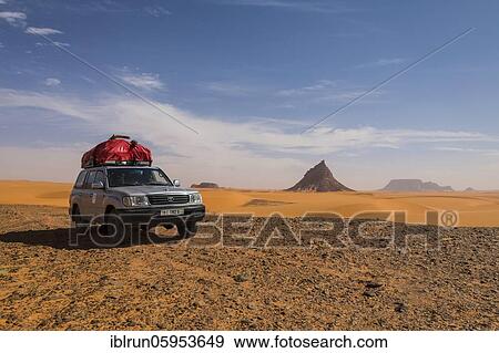 Stock Photo - Expedition jeep driving through the desert, Sahara, North of Chad. Fotosearch