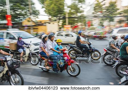 Family on a scooter in heavy traffic, motion blur, Ho Chi Minh City, Vietnam, Asia View Large Photo Image Stock Image - Family on a scooter in heavy traffic, motion blur, Ho Chi Minh City, Vietnam, Asia. Fotosearch