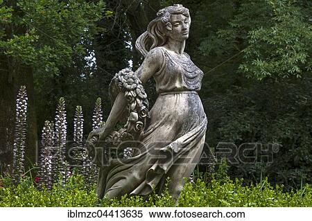 Female sculpture with a band of flowers behind acanthus (Acanthus), Parc Floral et Tropical de la Court d'Aron, Saint Cyr en Talmondais, Vandee, France, Europe View Large Photo Image Stock Photography - Female sculpture with a band of flowers behind acanthus (Acanthus), Parc Floral et Tropical de la Court d'Aron, Saint Cyr en Talmondais, Vandee, France, Europe. Fotosearch