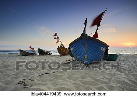 Stock Photo - Fishing boats on beach at sunrise, Kölpinsee, Usedom, Mecklenburg-Western Pomerania, Germany, Europe. Fotosearch