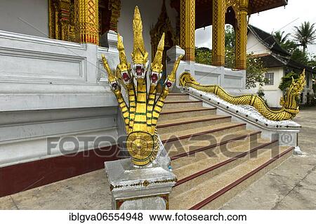 Five-headed mythological Naga serpent decorates the end of a stair railing, Wat Nong Sikhounmuang temple, Luang Prabang, Laos, Asia View Large Photo Image Stock Photo - Five-headed mythological Naga serpent decorates the end of a stair railing, Wat Nong Sikhounmuang temple, Luang Prabang, Laos, Asia. Fotosearch
