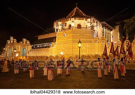 Stock Photo - Flag bearers and drummers in traditional costumes, Esala Perahera Buddhist festival, Sri Dalada Maligawa or Temple of the Sacred Tooth Relic, Kandy, Central Province, Sri Lanka, Asia. Fotosearch