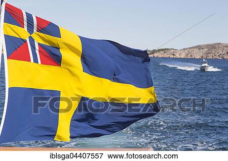 Stock Photo - Flag of Sweden atop boat, Bohuslän, West Sweden, Sweden, Europe. Fotosearch