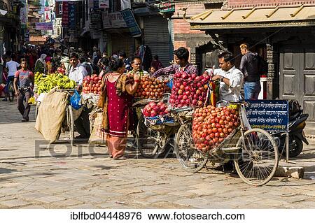 Fruit sellers, using bicycles, are offering apples and oranges on Indra Chowk market square, Kathmandu, Kathmandu District, Nepal, Asia View Large Photo Image Stock Photograph - Fruit sellers, using bicycles, are offering apples and oranges on Indra Chowk market square, Kathmandu, Kathmandu District, Nepal, Asia. Fotosearch