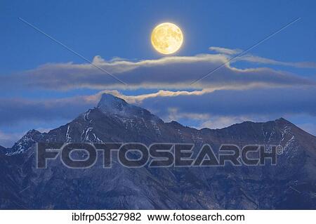 Stock Image - Full moon over Grisons Alps, Grisons, Switzerland, Europe. Fotosearch