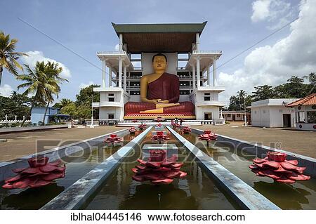 Giant Buddha statue, sitting Buddha fountain with artificial lotuses, Weherahena Temple, Matara, Southern Province, Sri Lanka, Asia View Large Photo Image Stock Photograph - Giant Buddha statue, sitting Buddha fountain with artificial lotuses, Weherahena Temple, Matara, Southern Province, Sri Lanka, Asia. Fotosearch