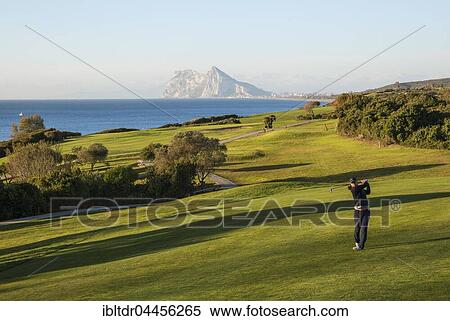 Golfer at La Alcaidesa Golf Resort with Mediterranean Sea and Rock of Gibraltar, Cádiz, Andalusia, Spain, Europe View Large Photo Image Stock Photography - Golfer at La Alcaidesa Golf Resort with Mediterranean Sea and Rock of Gibraltar, Cádiz, Andalusia, Spain, Europe. Fotosearch