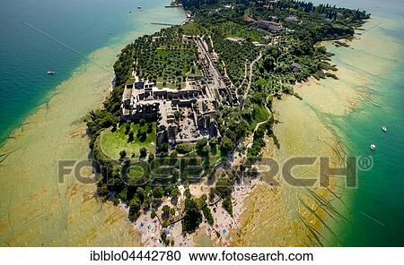 Stock Image - Grottoes of Catullus, archaeological park, peninsula in turquoise waters, Sirmione, Lake Garda, Lombardy, Italy, Europe. Fotosearch