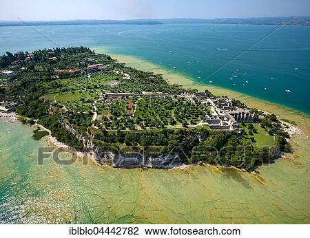 Stock Image - Grottoes of Catullus, archaeological park, peninsula in turquoise waters, Sirmione, Lake Garda, Lombardy, Italy, Europe. Fotosearch