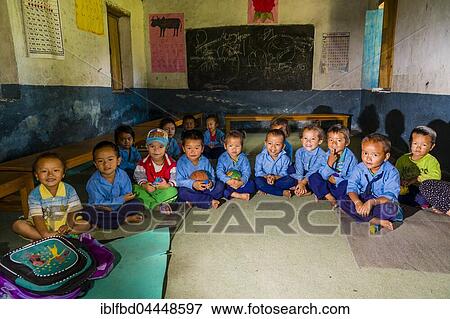 Group of children in blue dresses, sitting in a circle in the local kindergarten, Tatopani, Myagdi District, Nepal, Asia View Large Photo Image Stock Photo - Group of children in blue dresses, sitting in a circle in the local kindergarten, Tatopani, Myagdi District, Nepal, Asia. Fotosearch
