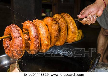 Hand holding fresh doughnuts on a wooden stick, Bandipur, Tanahun District, Nepal, Asia View Large Photo Image Stock Photo - Hand holding fresh doughnuts on a wooden stick, Bandipur, Tanahun District, Nepal, Asia. Fotosearch