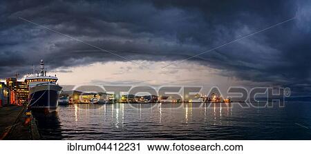 Harbour and Queens Wharf illuminated at sunset with dark storm clouds, Wellington, North Island, New Zealand, Oceania View Large Photo Image Stock Image - Harbour and Queens Wharf illuminated at sunset with dark storm clouds, Wellington, North Island, New Zealand, Oceania. Fotosearch
