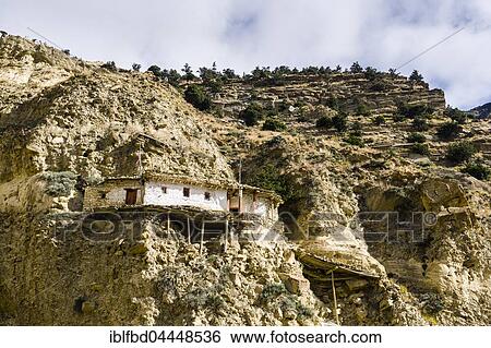 Stock Photograph - Hermitage buildt in rocks, Marpha, Mustang District, Nepal, Asia. Fotosearch