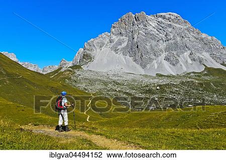 Hiker in front of the summit Sulzfluh, St. Antönien, Prättigau, Canton of Grisons, Switzerland, Europe View Large Photo Image Stock Image - Hiker in front of the summit Sulzfluh, St. Antönien, Prättigau, Canton of Grisons, Switzerland, Europe. Fotosearch