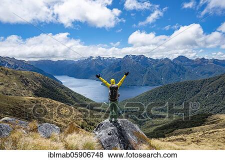 Hiker looks into the distance, stretches his arms in the air, view of the South Fiord of Lake Te Anau, Murchison Mountains in the background, on the Kepler Track, Great Walk, Fiordland National Park, Southland, New Zealand, Oceania View Large Photo Image Stock Photo - Hiker looks into the distance, stretches his arms in the air, view of the South Fiord of Lake Te Anau, Murchison Mountains in the background, on the Kepler Track, Great Walk, Fiordland National Park, Southland, New Zealand, Oceania. Fotosearch