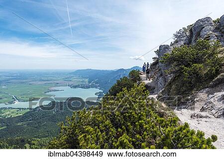 Stock Photo - Hikers ar Heimgarten narrow ridge, The Herzogstand, Lake Kochel, Upper Bavaria, Bavaria, Germany, Europe. Fotosearch