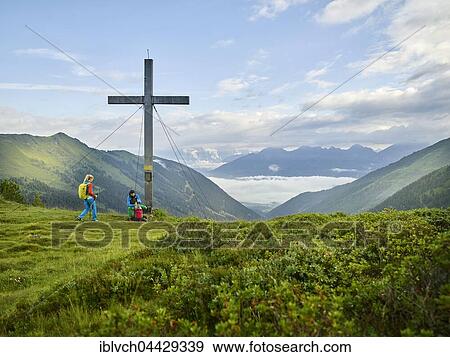 Hikers at summit cross, Kemater Alm, Kalkkögel, Tyrol, Austria, Europe View Large Photo Image Stock Photo - Hikers at summit cross, Kemater Alm, Kalkkögel, Tyrol, Austria, Europe. Fotosearch