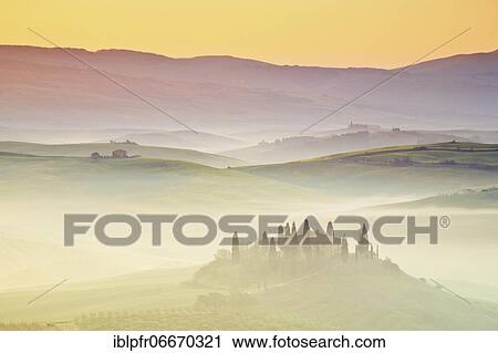 Hilly landscape with cornfields and cypresses, manor house, group of cypresses, traditional Tuscany stone house, fog, morning atmosphere, in spring, Tuscany, Italy, Europe View Large Photo Image Stock Image - Hilly landscape with cornfields and cypresses, manor house, group of cypresses, traditional Tuscany stone house, fog, morning atmosphere, in spring, Tuscany, Italy, Europe. Fotosearch