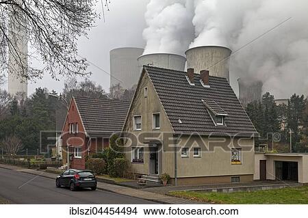 Houses in front of power plant Niederaussem, Auenheim district, Bergheim, Rhenish lignite mining area, North Rhine-Westphalia, Germany, Europe View Large Photo Image Picture - Houses in front of power plant Niederaussem, Auenheim district, Bergheim, Rhenish lignite mining area, North Rhine-Westphalia, Germany, Europe. Fotosearch