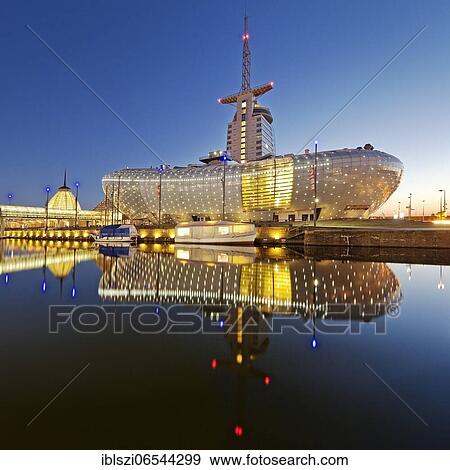 Stock Photo - Illuminated Klimahaus Bremerhaven in the evening, Havenwelten, Bremerhaven, Federal State of Bremen, Germany, Europe. Fotosearch