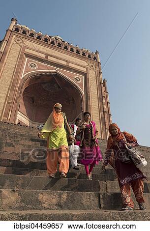 Stock Photo - Indian women descending stairs from Buland Darwaza, Gate of Magnificence, Great Gate, Fatehpur Sikri, India, Asia. Fotosearch