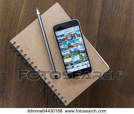 Instagram picture gallery displayed on smartphone screen, notebook and pen on a wooden table View Large Photo Image Stock Photograph - Instagram picture gallery displayed on smartphone screen, notebook and pen on a wooden table. Fotosearch