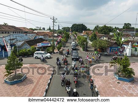 Stock Image - Intersection, traffic, street with rickshaws, cars and cyclists, Yogyakarta, Java, Indonesia, Asia. Fotosearch