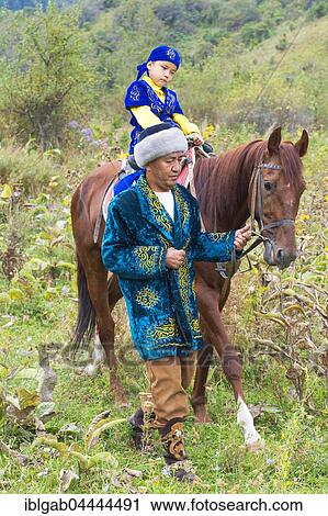 Kazakh man walking around with his son on a horse after Circumcision Sundet Toi ceremony, Kazakh ethnographic village aul Gunny, Talgar, Almaty, Kazakhstan, Asia View Large Photo Image Stock Image - Kazakh man walking around with his son on a horse after Circumcision Sundet Toi ceremony, Kazakh ethnographic village aul Gunny, Talgar, Almaty, Kazakhstan, Asia. Fotosearch