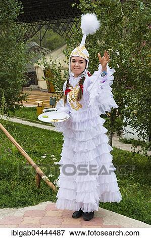 Stock Photo - Kazakh woman meeting guests with candies, Kazakh ethnographic village aul Gunny, Talgar, Almaty, Kazakhstan, Asia. Fotosearch