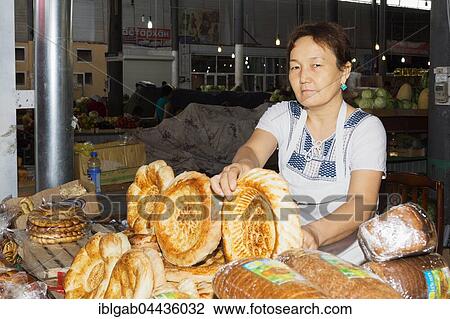 Stock Image - Kazakh Woman selling bread, Samal Bazar, Shymkent, South Region, Kazakhstan, Central Asia, For editorial use only, Asia. Fotosearch