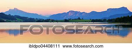 Lake Irrsee at dusk with Salzkammergut and the Dachstein Mountains, near Zell am Moos, Upper Austria, Austria, Europe View Large Photo Image Stock Image - Lake Irrsee at dusk with Salzkammergut and the Dachstein Mountains, near Zell am Moos, Upper Austria, Austria, Europe. Fotosearch