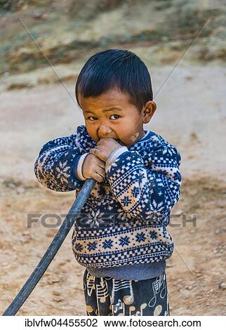 Little boy blowing into hose, Palaung hilltribe, Palaung Village in Kyaukme, Shan State, Myanmar, Asia View Large Photo Image Stock Image - Little boy blowing into hose, Palaung hilltribe, Palaung Village in Kyaukme, Shan State, Myanmar, Asia. Fotosearch