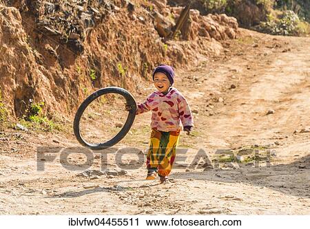 Little boy runs with tire as toy, Palaung hilltribe, Palaung Village in Kyaukme, Shan State, Myanmar, Asia View Large Photo Image Stock Image - Little boy runs with tire as toy, Palaung hilltribe, Palaung Village in Kyaukme, Shan State, Myanmar, Asia. Fotosearch