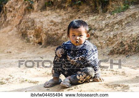 Little boy sitting on the ground, Palaung hilltribe, Palaung Village in Kyaukme, Shan State, Myanmar, Asia View Large Photo Image Picture - Little boy sitting on the ground, Palaung hilltribe, Palaung Village in Kyaukme, Shan State, Myanmar, Asia. Fotosearch