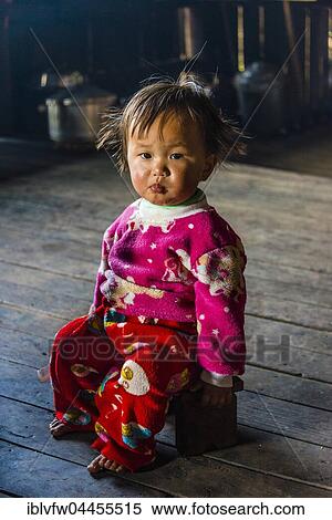 Little girl sits on stool in hut, Palaung hilltribe, Palaung Village in Kyaukme, Shan State, Myanmar, Asia View Large Photo Image Stock Photography - Little girl sits on stool in hut, Palaung hilltribe, Palaung Village in Kyaukme, Shan State, Myanmar, Asia. Fotosearch