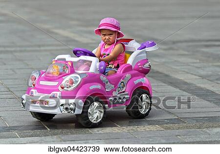 Little girl with frowning face rides in electric toy car, Genghis Khan Square, Ulaanbaatar, Mongolia, Asia View Large Photo Image Stock Photo - Little girl with frowning face rides in electric toy car, Genghis Khan Square, Ulaanbaatar, Mongolia, Asia. Fotosearch