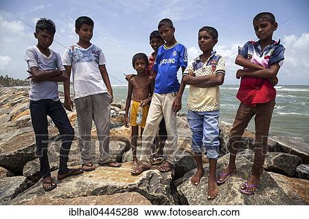 Local children on breakwater in harbour, Beruwela, Western Province, Sri Lanka, Asia View Large Photo Image Stock Photo - Local children on breakwater in harbour, Beruwela, Western Province, Sri Lanka, Asia. Fotosearch