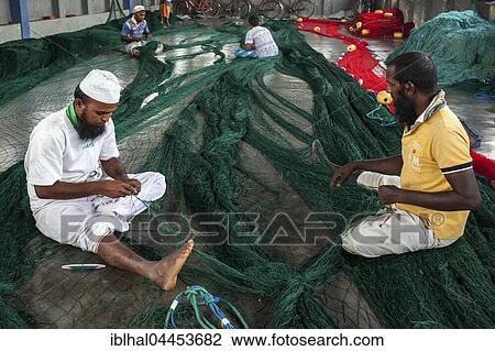 Local men repairing fishing nets in hall at harbour, Beruwela, Western Province, Sri Lanka, Asia View Large Photo Image Stock Image - Local men repairing fishing nets in hall at harbour, Beruwela, Western Province, Sri Lanka, Asia. Fotosearch