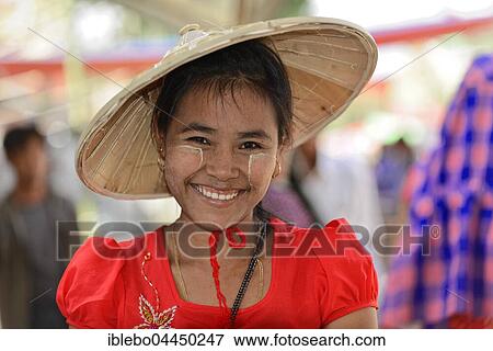 Local woman with straw hat and Thanaka paste on her face, smiling, Mandalay, Myanmar, Asia View Large Photo Image Stock Photo - Local woman with straw hat and Thanaka paste on her face, smiling, Mandalay, Myanmar, Asia. Fotosearch