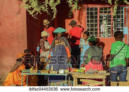 Locals in colorful clothes at a stall, Opuwo, Namibia, Africa View Large Photo Image Stock Photograph - Locals in colorful clothes at a stall, Opuwo, Namibia, Africa. Fotosearch