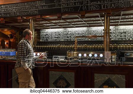 Man holding a glass of beer at Ølhallen, oldest pub in Tromso, Troms, Norway, Europe View Large Photo Image Stock Photography - Man holding a glass of beer at Ølhallen, oldest pub in Tromso, Troms, Norway, Europe. Fotosearch