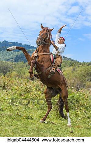 Man on an upright horse, Kazakh ethnographic village aul Gunny, Talgar, Almaty, Kazakhstan, Asia View Large Photo Image Picture - Man on an upright horse, Kazakh ethnographic village aul Gunny, Talgar, Almaty, Kazakhstan, Asia. Fotosearch