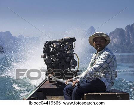 Man on powerboat, Ratchaprapha, Cheow Lan Lake, Khao Sok National Park, Surat Thani Province, Thailand, Asia View Large Photo Image Stock Photography - Man on powerboat, Ratchaprapha, Cheow Lan Lake, Khao Sok National Park, Surat Thani Province, Thailand, Asia. Fotosearch