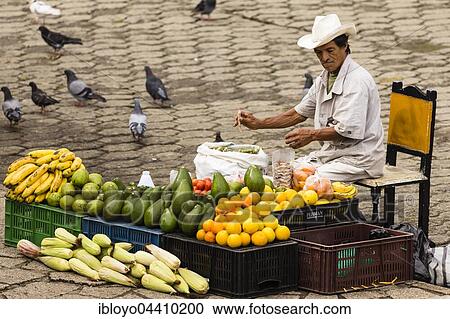 Stock Image - Man selling fruits and vegetables in the street, Antioquia, Colombia, South America. Fotosearch