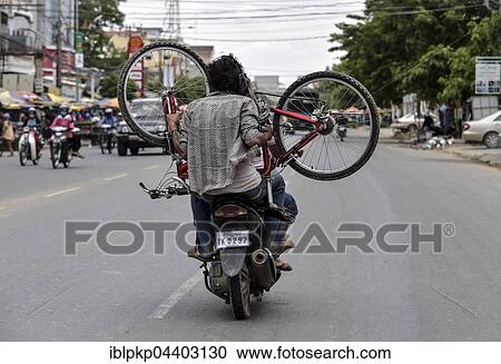 Man with moped carries a bicycle, Phnom Penh, Cambodia, Asia View Large Photo Image Stock Image - Man with moped carries a bicycle, Phnom Penh, Cambodia, Asia. Fotosearch