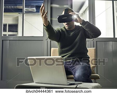 Stock Image - Man with VR goggles, virtual reality glasses. Fotosearch