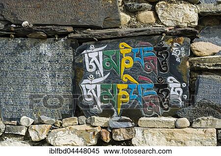 Mani stones with engraved colorful tibetan mantra at a wall, Manang, Manang District, Nepal, Asia View Large Photo Image Stock Photography - Mani stones with engraved colorful tibetan mantra at a wall, Manang, Manang District, Nepal, Asia. Fotosearch