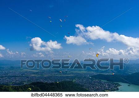 Many paragliders are flying over Pokhara and Phewa Lake, Sarangkot, Kaski District, Nepal, Asia View Large Photo Image Stock Photography - Many paragliders are flying over Pokhara and Phewa Lake, Sarangkot, Kaski District, Nepal, Asia. Fotosearch